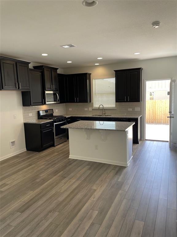 kitchen featuring sink, plenty of natural light, a center island, and appliances with stainless steel finishes