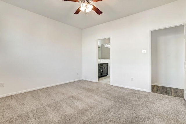 unfurnished bedroom featuring carpet flooring, connected bathroom, and baseboards