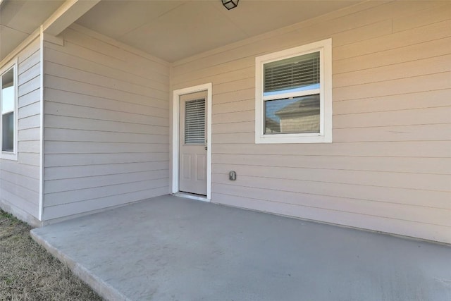 property entrance featuring a patio area