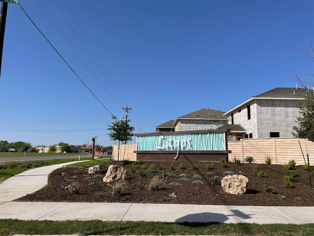 community / neighborhood sign with fence