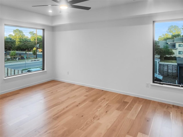 spare room with light hardwood / wood-style flooring and ceiling fan