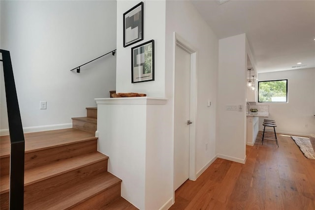 stairs with hardwood / wood-style floors