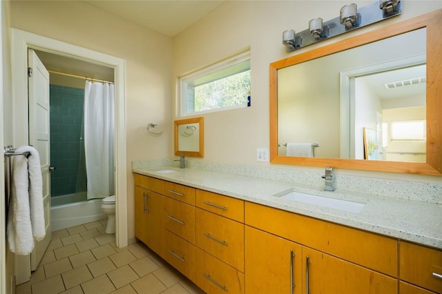 full bathroom featuring tile patterned flooring, vanity, toilet, and shower / bathtub combination with curtain