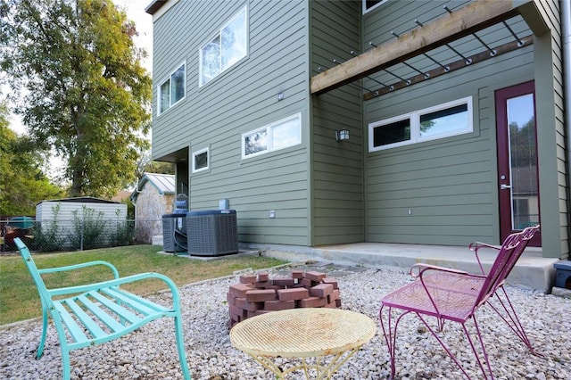 view of patio / terrace featuring central air condition unit and an outdoor fire pit