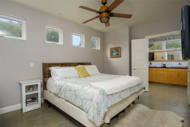 bedroom featuring sink, multiple windows, and ceiling fan