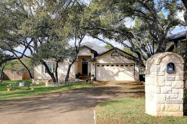 view of front of property with a garage and a front lawn