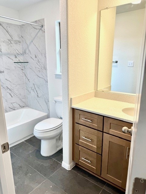 full bathroom featuring tile patterned floors, vanity, toilet, and tiled shower / bath combo