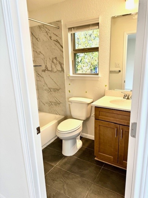 full bathroom featuring tile patterned flooring, vanity, toilet, and tiled shower / bath