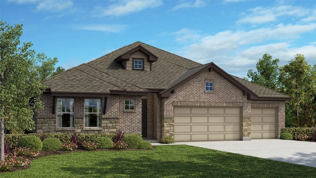 view of front of property featuring a garage and a front lawn