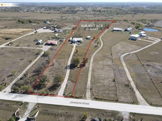 birds eye view of property with a rural view