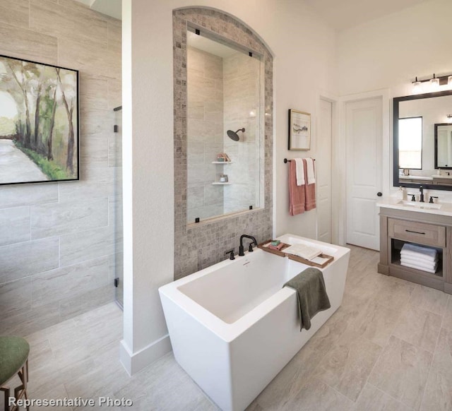 bathroom featuring separate shower and tub and vanity