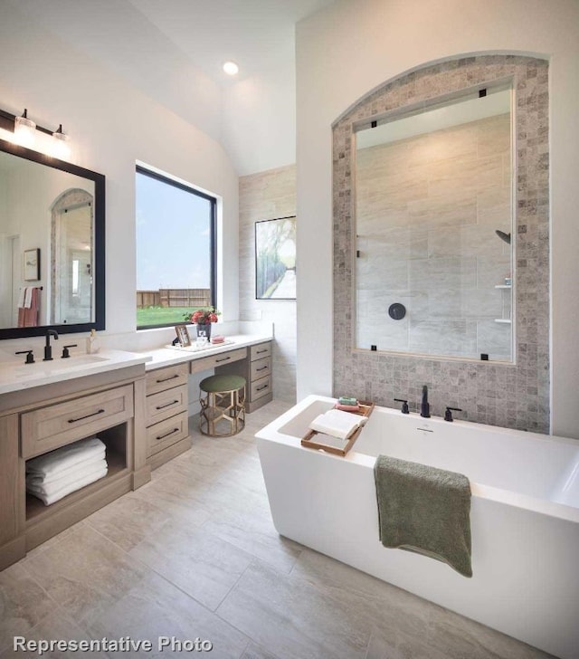 bathroom featuring vanity, separate shower and tub, tile walls, and vaulted ceiling