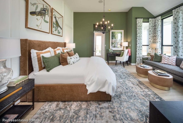 bedroom with light hardwood / wood-style floors, an inviting chandelier, and multiple windows