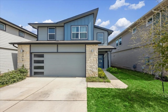 view of front of house with a garage and a front lawn