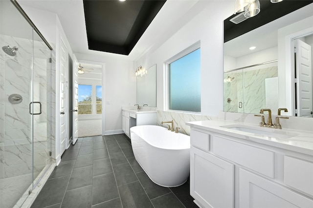 149 Golden Sage Ave, Georgetown, TX 78633 - full bathroom with a marble finish shower, two vanities, a freestanding tub, ceiling fan, and recessed lighting