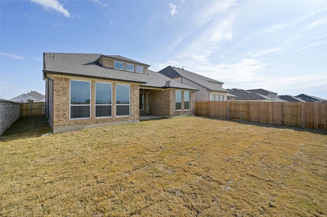 149 Golden Sage Ave, Georgetown, TX 78633 - back of property with a fenced backyard, brick siding, and a shingled roof