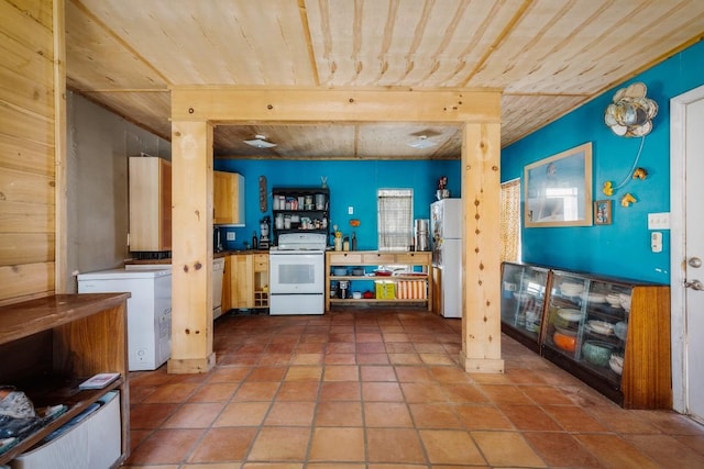 kitchen with tile patterned floors and white appliances