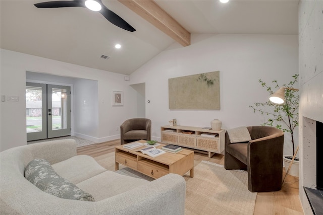 living room featuring vaulted ceiling with beams, ceiling fan, hardwood / wood-style floors, and french doors