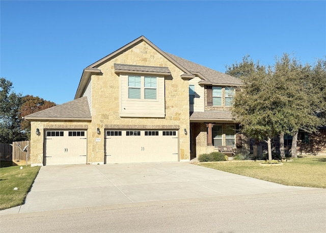 view of front of home with a garage and a front lawn