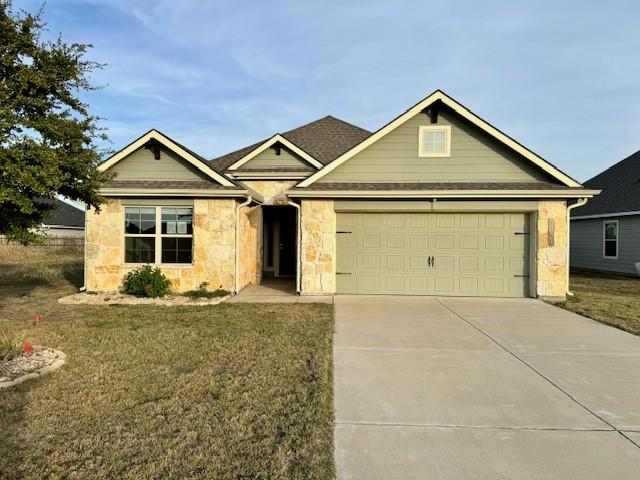 view of front of property with a front lawn and a garage