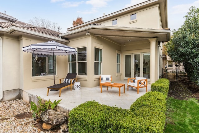 rear view of property featuring french doors and a patio