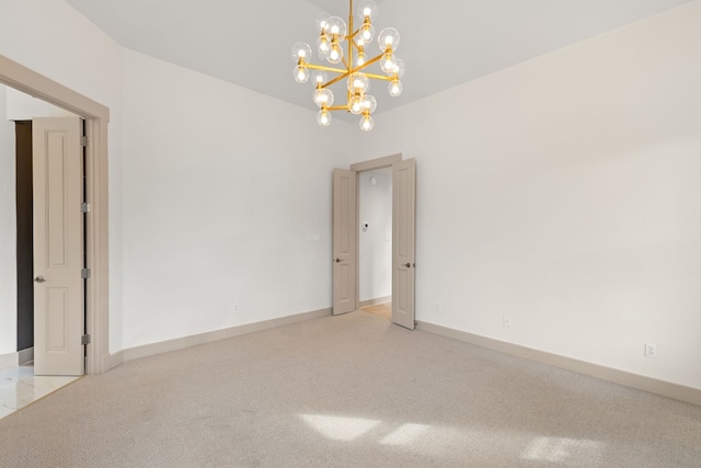 unfurnished room with an inviting chandelier