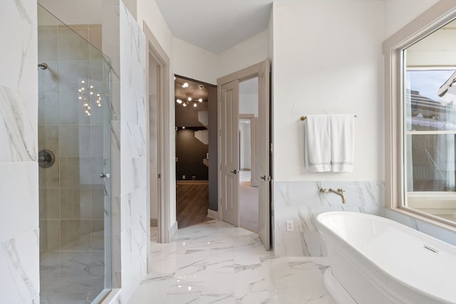 bathroom featuring separate shower and tub and tile walls