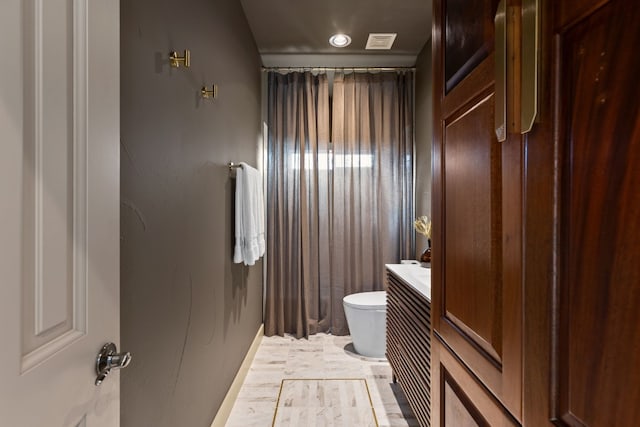 bathroom featuring hardwood / wood-style flooring, vanity, and toilet