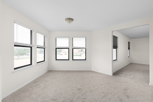 spare room with light colored carpet