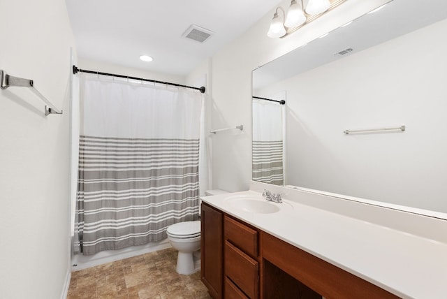 full bathroom with vanity, shower / bath combination with curtain, and toilet