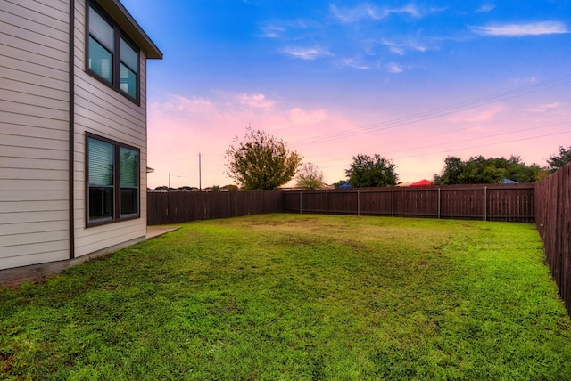 view of yard at dusk