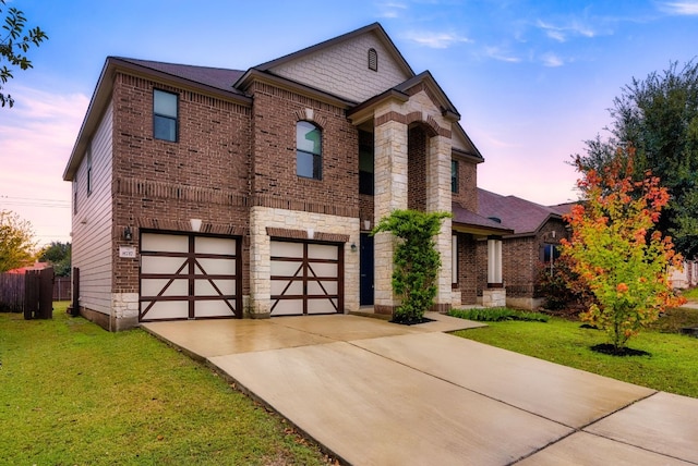 view of front of house with a garage and a lawn