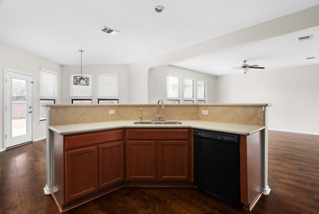 kitchen with ceiling fan, sink, hanging light fixtures, dark wood-type flooring, and black dishwasher