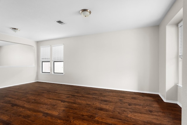 empty room featuring dark hardwood / wood-style flooring