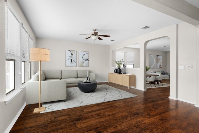 living room featuring a wealth of natural light, ceiling fan, and wood-type flooring