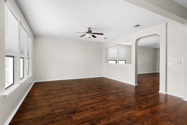 spare room with dark hardwood / wood-style flooring, plenty of natural light, and ceiling fan