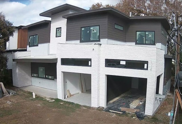 2004 Pequeno St, Austin, TX 78757 - rear view of property featuring a garage and dirt driveway