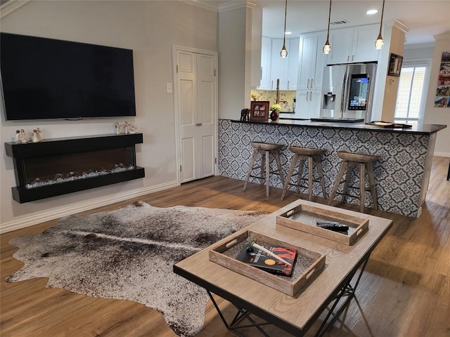 living room with hardwood / wood-style floors and ornamental molding