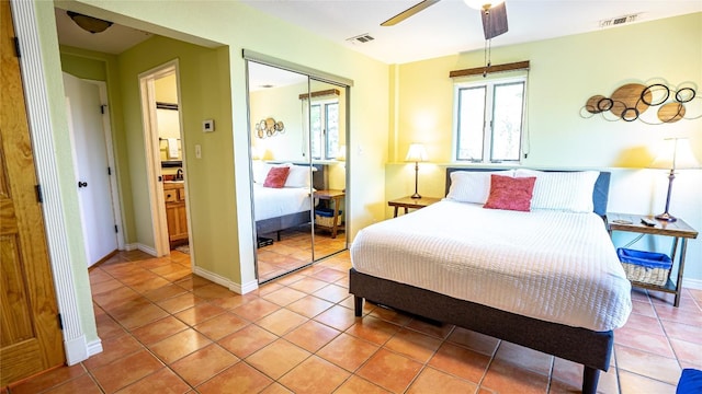 bedroom featuring light tile patterned floors, a closet, and ceiling fan