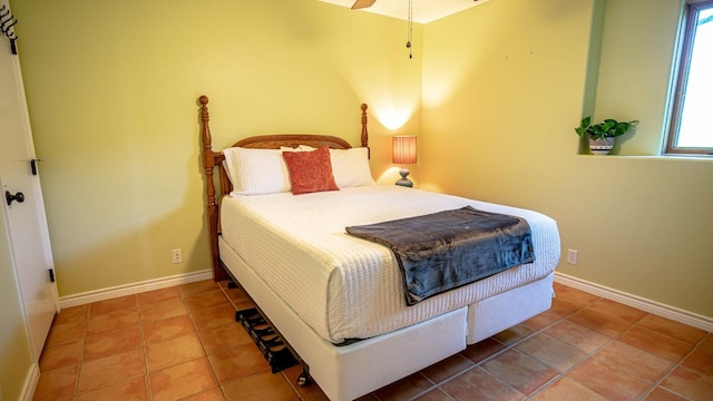 tiled bedroom featuring ceiling fan