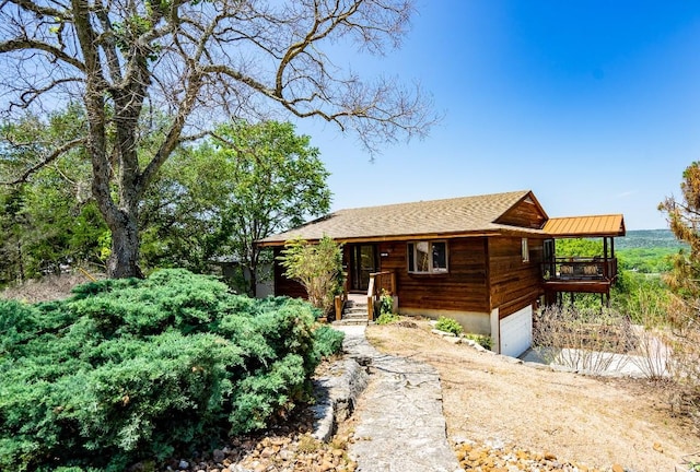 log-style house featuring a garage