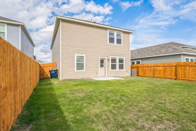 rear view of property with a yard