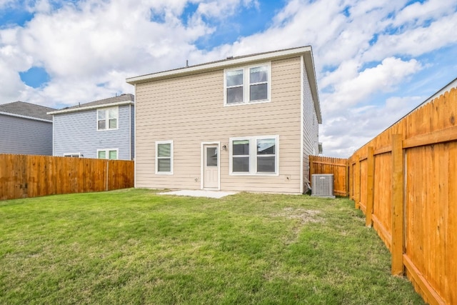 rear view of house featuring a yard and central AC unit