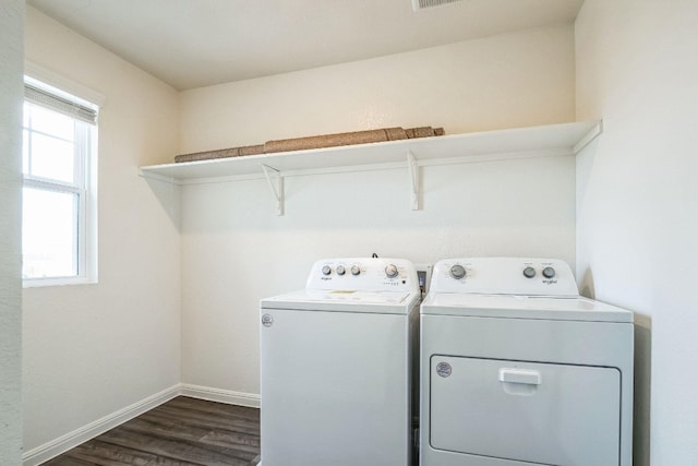 laundry area with washer and clothes dryer and dark wood-type flooring