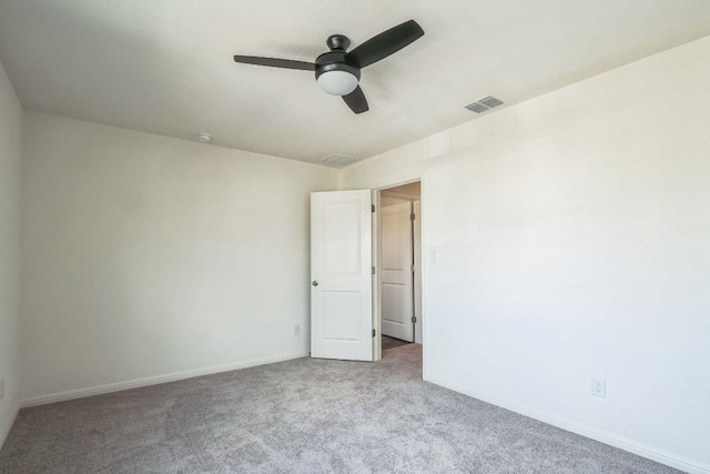 empty room featuring light colored carpet and ceiling fan