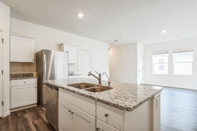 kitchen featuring white cabinetry, sink, dark wood-type flooring, a kitchen island with sink, and appliances with stainless steel finishes