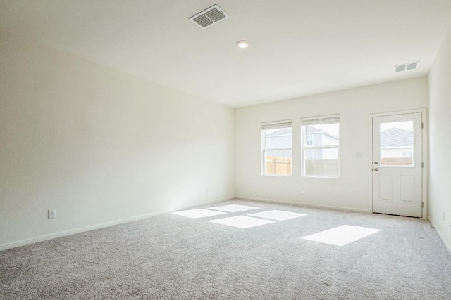 unfurnished room with light carpet