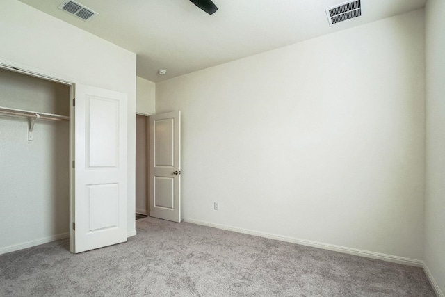 unfurnished bedroom with light colored carpet, a closet, and ceiling fan