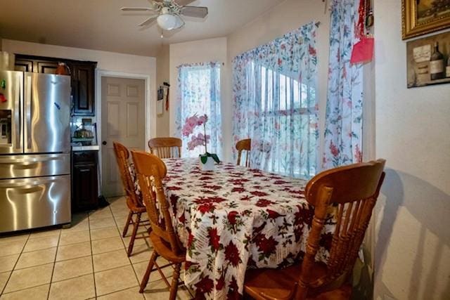 tiled dining area featuring ceiling fan