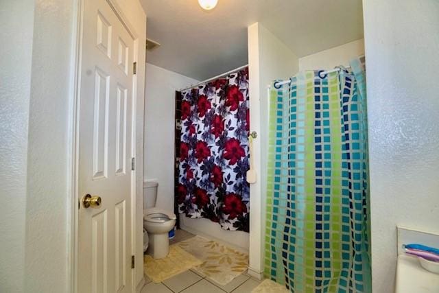 bathroom featuring tile patterned flooring and toilet